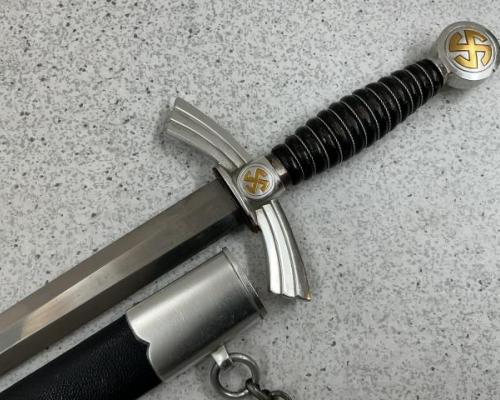 Complete with aluminum chained hanger which has six upper and nine lower ringlets with a clip marked “GES. GESCH” on the reverse side.